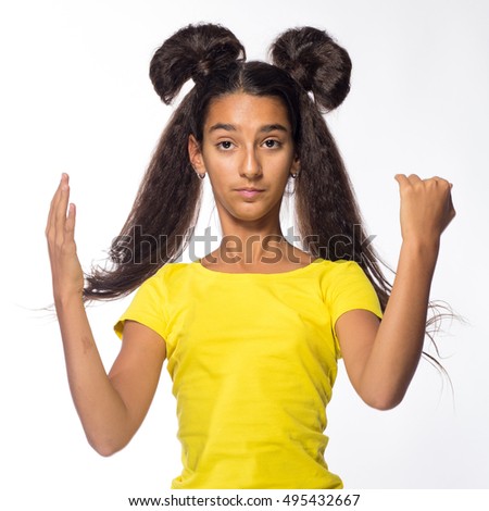 Emotional young brunette girl with long hair in yellow shirt on a white background