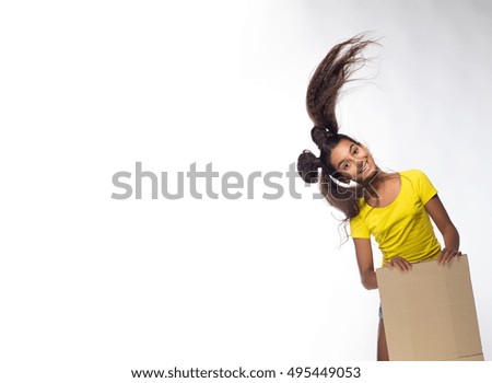 Emotional young brunette girl with long hair in yellow t-shirt with beige cardboard sheet for records on a white background