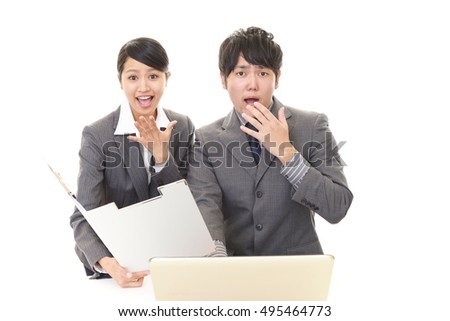 Surprised businessman and businesswoman 