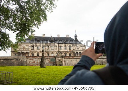Man taking photos of mansion 