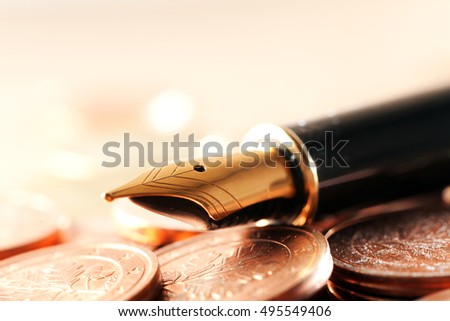 Beautiful fountain pen closeup and coins.Photo closeup Pen