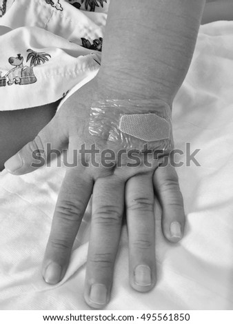Black and White Picture : Baby hand with wounded of water proof bandage in hospital 