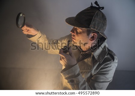 sherlock holmes in studio etective at work with magnifying glass and pipe
 Royalty-Free Stock Photo #495572890
