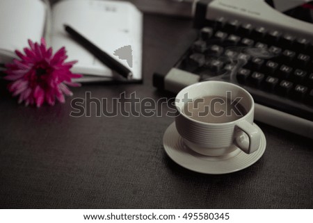 Vintage typewriter and coffee on stone board