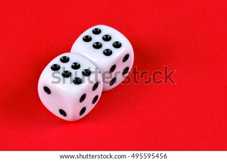 Two white dices against a red background