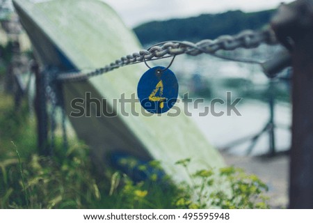 A tag with the number four on a chain outside