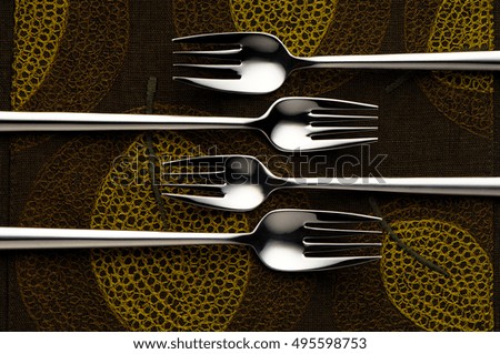 Forks arranged on decorative dinner table
