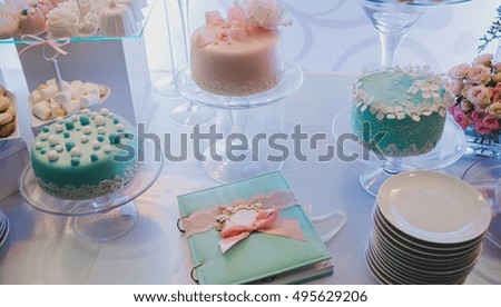 Wedding book and mint sweets stand on the buffet