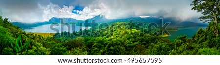 One of the main popular attractions of tropical island Bali visited daily by hundreds of tourists from around the world for look amazing scenic top view, two lakes Batur and Batur volcano / Indonesia Royalty-Free Stock Photo #495657595