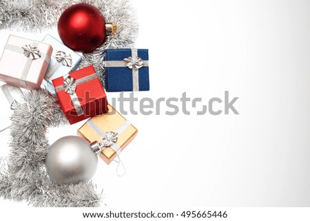 Small boxes for christmas gift, christmas balls and christmas tinsel on white background, Empty space for text