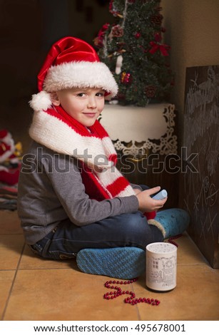Boy in Santa hat draws