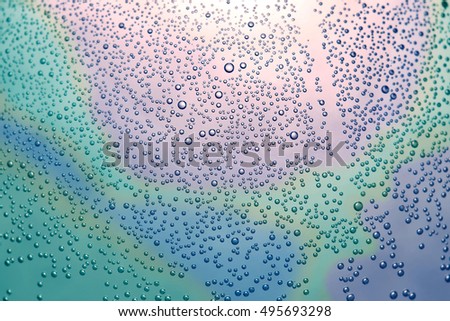 Bubbles and water drops over the walls of the glass vessel
