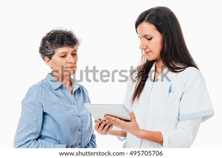 Young doctor showing on the tablet the test results to her patient - isolated on white.