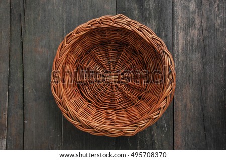 wood weave fruit basket on wood texture, top view Royalty-Free Stock Photo #495708370