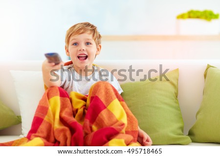 excited boy, kid watching tv at home