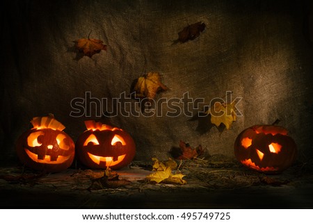 Halloween pumpkin head jack lantern on burlap background