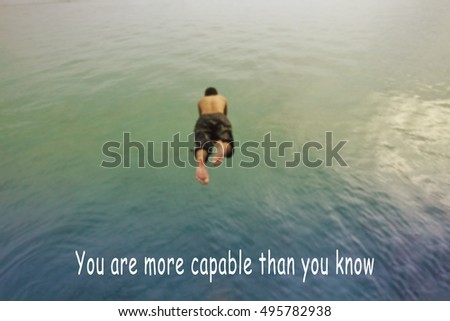 Inspirational quote on blurred background with a man dive into sea.