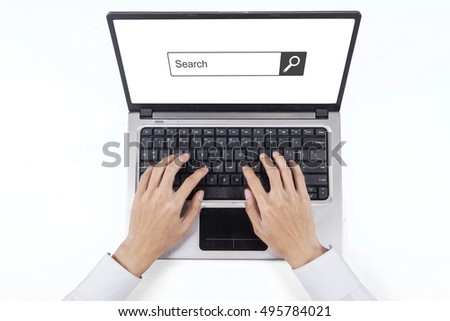 Businessman hand typing on the laptop computer with search bar on the screen