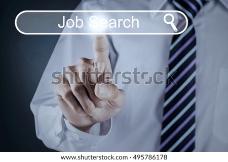 Concept of Job Search with businessman hand pressing a virtual job search button on the futuristic interface