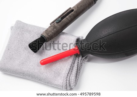 Lens and camera cleaner accessories isolated on a white background.