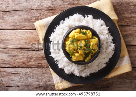Chicken Korma of coconut and cream sauce served in a rice. horizontal view from above
 Royalty-Free Stock Photo #495798751