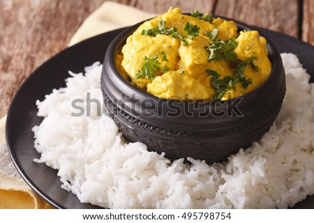 Indian chicken Korma with basmati rice close-up on the table. horizontal
 Royalty-Free Stock Photo #495798754