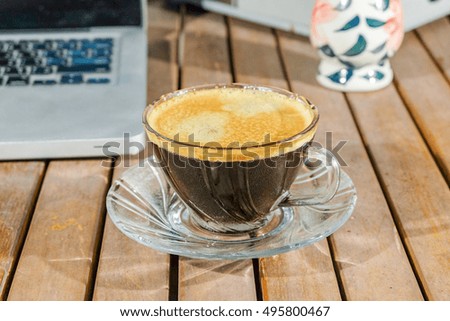 A cup of coffee in warm morning sun.