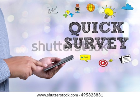 QUICK SURVEY              person holding a smartphone on blurred cityscape background