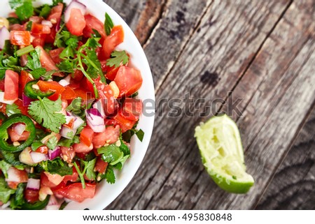 Delicious, spicy sauce Pico de Gallo also called salsa Fresca. Traditional recipe, fresh tomatoes, red onion, cilantro, lime juice and spicy jalapenos. National Mexican cuisine. Top view