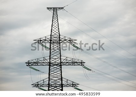metal Bearing high voltage power line during sunset or sunrise.