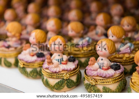 Ceramic doll small girl sitting in a row lined up waiting to sell many beautifully.