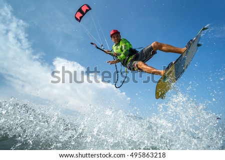 A kite surfer rides the waves
 Royalty-Free Stock Photo #495863218