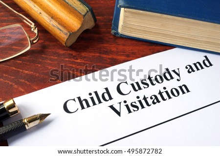 Child Custody and Visitation written on a paper and a book. Royalty-Free Stock Photo #495872782