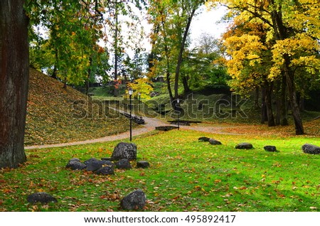 Autumn park, beautiful orange and red trees. Cesis, Latvia. 