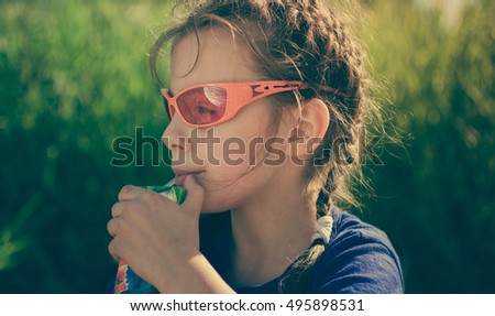 A child is drinking juice.