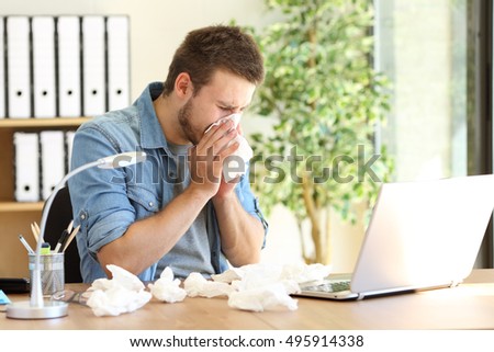 Portrait of a sick entrepreneur blowing in a wipe at office with a lot of used wipes on the desk Royalty-Free Stock Photo #495914338