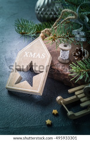 Christmas background with fir tree and decorations on old wooden cutting board. Winter holidays concept with copy space. Retro style toned.