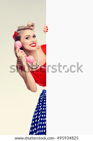 Woman with phone in pin-up style, showing signboard. Model in retro fashion and vintage shoot - call center and customer support service concept. Copyspace area for advertising slogan or text message.