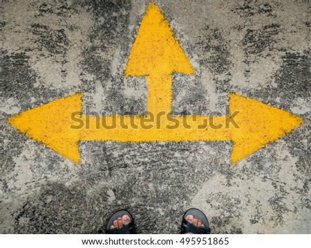 man stand with traffic direction arrow on the road, three way direction