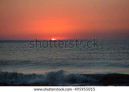 Early morning, the image of the sea at the sunrise. Waves, red sky. Landscape. Holiday
