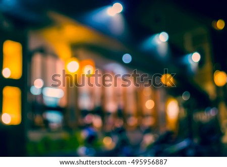 image of blur restaurant or cafe in night time with bokeh  for background usage . (vintage tone)