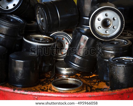 Closeup picture of old oil filters for automobile. Picture of motor oil as product of oil refining industry.