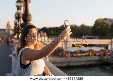 Lucky woman in Paris taking a selfie to post on social networks