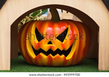 Halloween punpkin in wood house for halloween holiday background