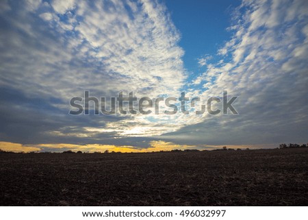 Epic sky with gorgeous clouds over empty field.