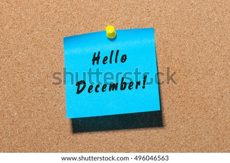 Hello December written on blue paper pinned at cork notice board with empty space for text. Eve, Christmas and New year time concept