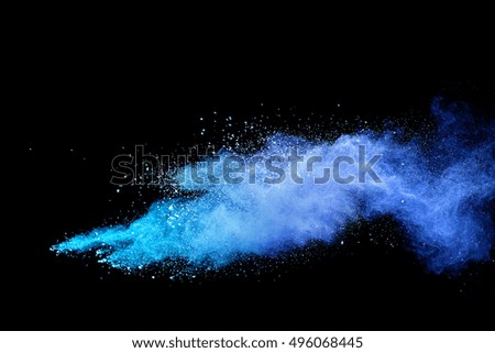 Blue powder explosion on black background. Mauve color cloud. Blue dust explode. Freeze motion paint Holi.