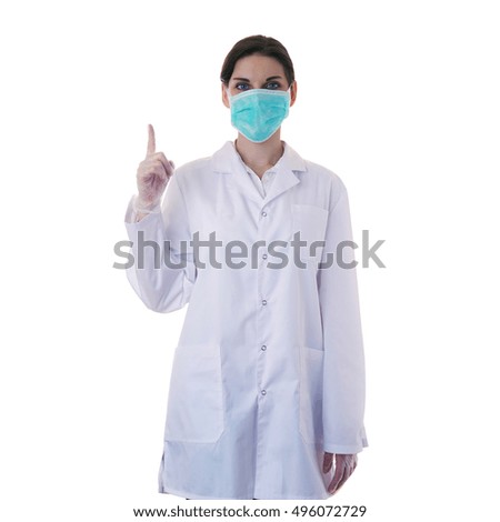Female doctor in white coat over white isolated background in surgical mask pointing up, healthcare, profession and medicine concept