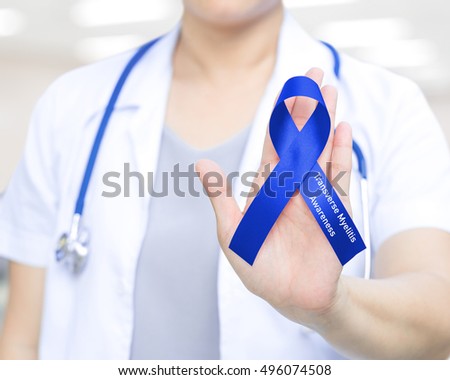 Female doctor in white uniform with royal blue ribbon awareness in hand as stop sign for Transverse myelitis awareness , healthcare, medical concept.