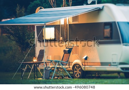 Travel Trailer Caravaning. RV Park Camping at Night.  Royalty-Free Stock Photo #496080748
